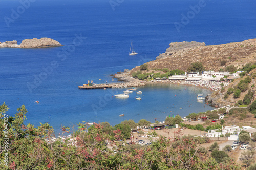 Panoramic view of small sandy beach in Lindos town at island Rhodes on sunny day