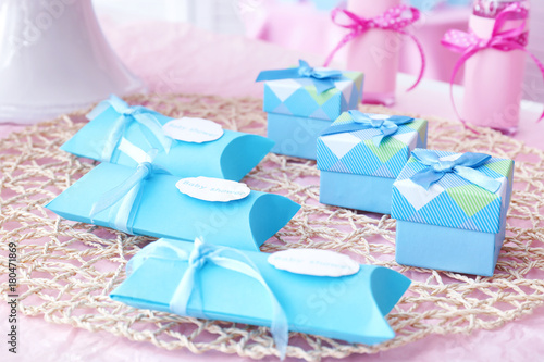 Obraz na plátně Boxes with baby shower favors on table
