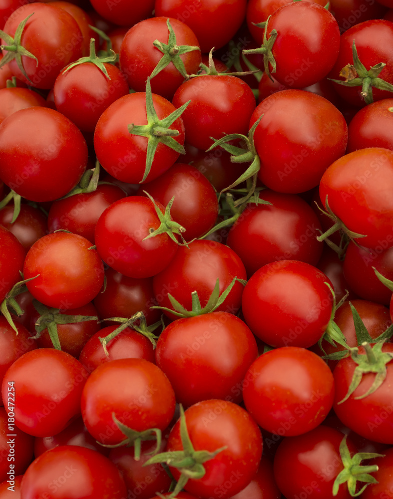 Delicious red tomatoes. A pile of tomatoes. Summer tray market agriculture farm full of organic tomatoes. Fresh tomatoes. It can be used as background. (selective focus)