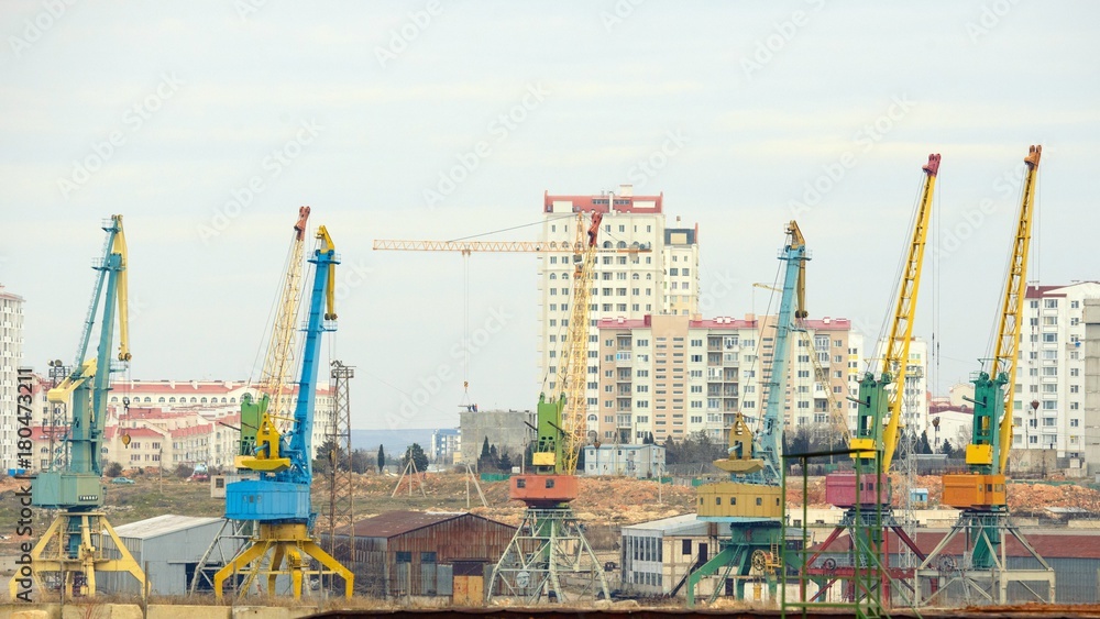 Lot of cranes on a large building construction
