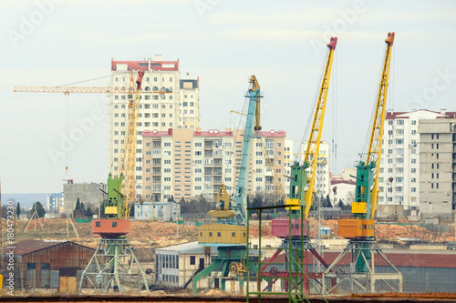 Lot of cranes on a large building construction