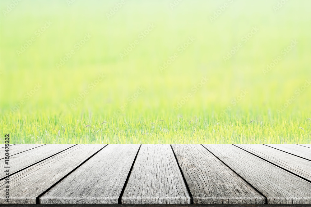 Empty wooden table green wheat field natural background blurred. concept party, display, foods, products,natural,farm,organic. Empty wooden table green wheat field natural background blurred. concept party, display, foods, products,natural,farm,organic.