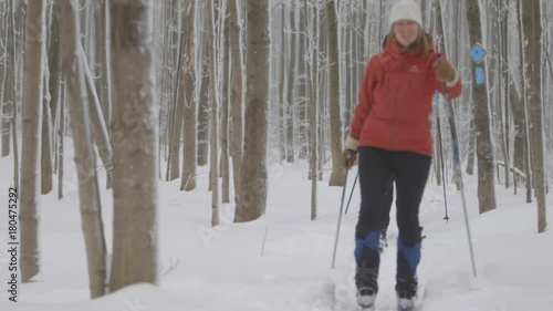 A rack shot of two skiers going down a trail towards a camera