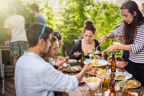 Group of students having fun while they prepare a bbq