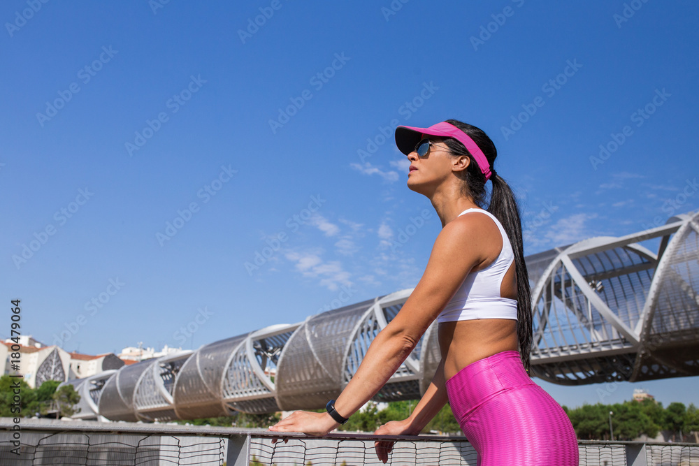Fit middle-aged woman resting after training in park