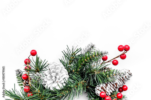 Christmas wreath woven of spruce branches with red berries on white background top view copyspace