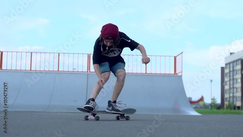 Skateboarder makes kickflip in slow motion