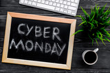 Words cyber monday written on blackboard near keyboard on grey wooden background top view