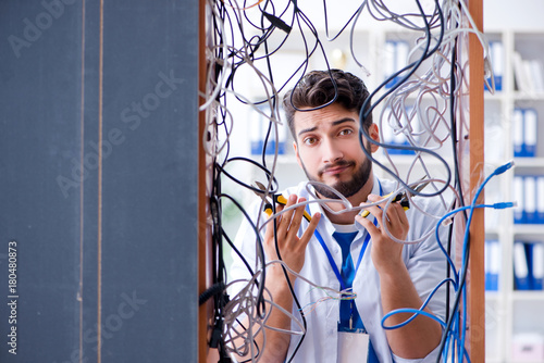 Electrician trying to untangle wires in repair concept