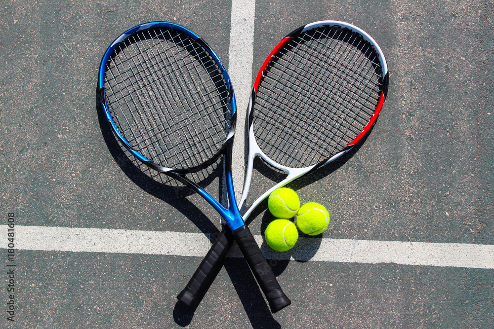 Tennis racquets with three balls On a tennis court