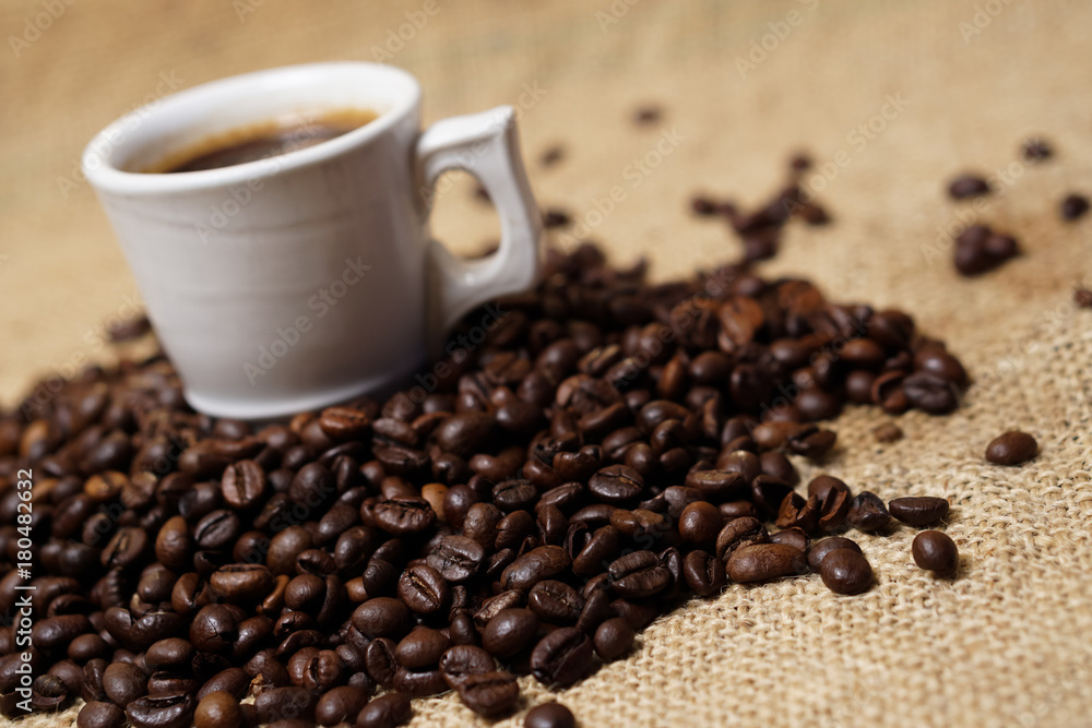 Cup of coffee on sackcloth with coffee beans Cup of coffee on sackcloth with coffee beans