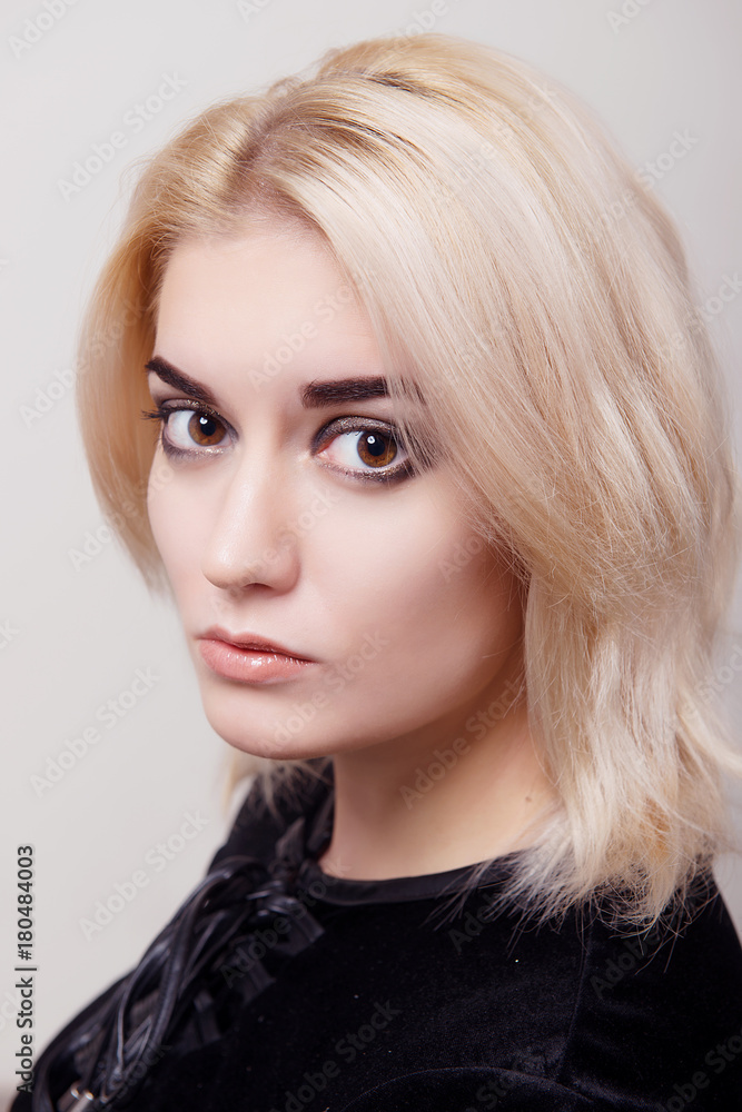 Blonde girl with bright makeup and clean skin on a white isolate close-up Blonde girl with bright makeup and clean skin on a white isolate close-up