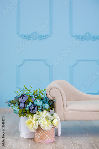 Studio interier decoration with flowers in light warm colors and casual vintage furniture photo