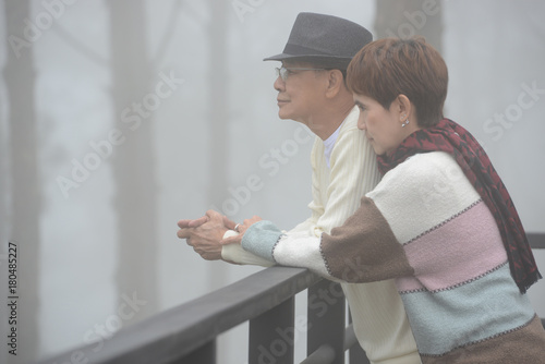 Portrait of happy romantic senior couple outdoor at the sea of fog