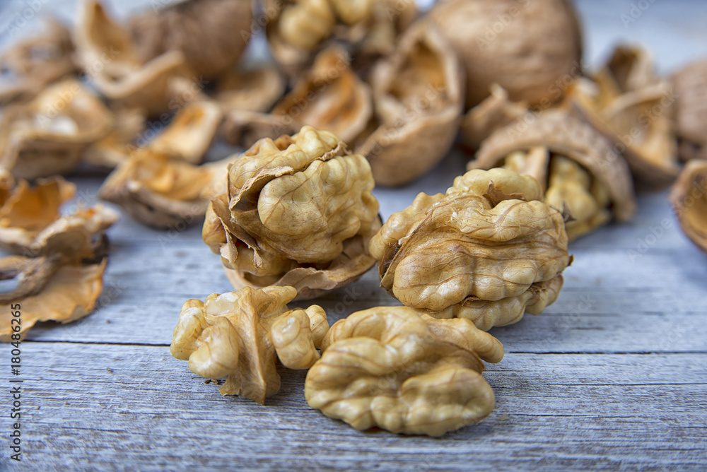 Walnut kernels and whole walnuts on the rustic grunge table. Walnut kernels and whole walnuts on the rustic grunge table.