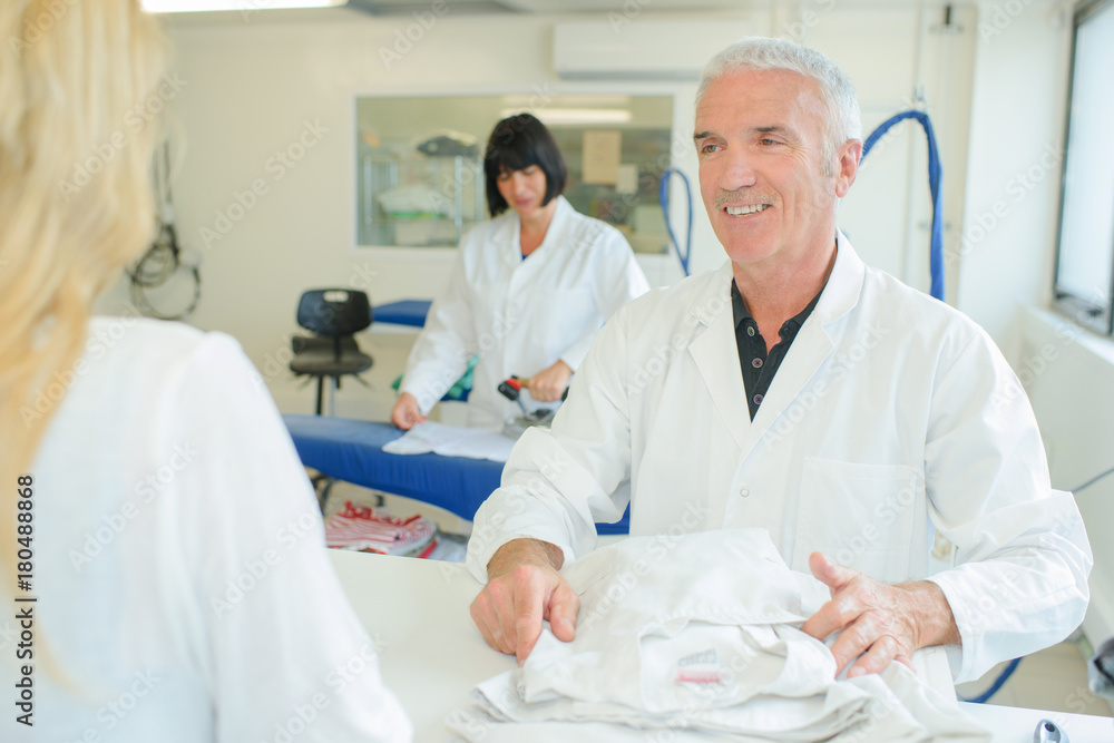 Man with customer in professional laundry Man with customer in professional laundry