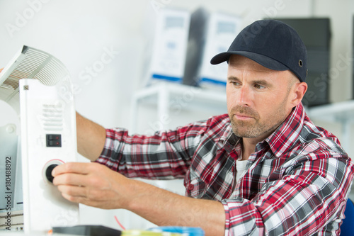 plumber inspecting the radiator