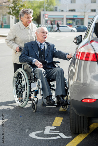 senior man in wheelchair with wife