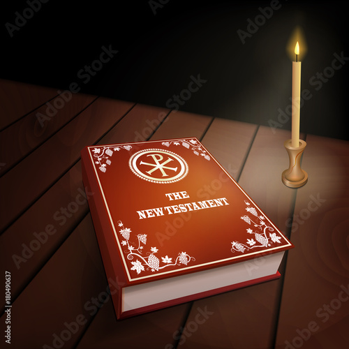 New Testament book on wood table with candle