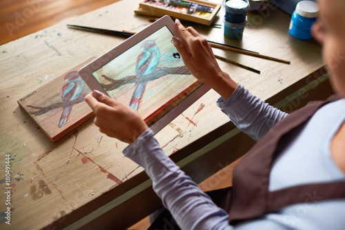 High angle closeup of unrecognizable young woman taking photo of artwork to share on social media