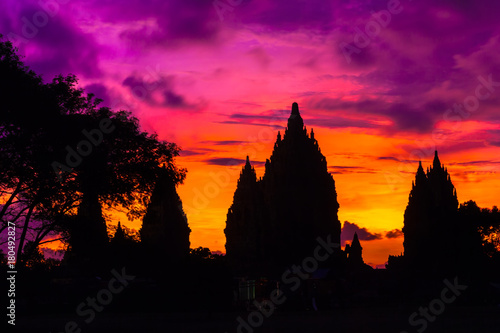 Silhouette of a temple complex against the background of a fiery red orange purple sky after sunset. Candi Prambanan Hindu Temple, Yogyakarta, Jawa, Indonesia.
