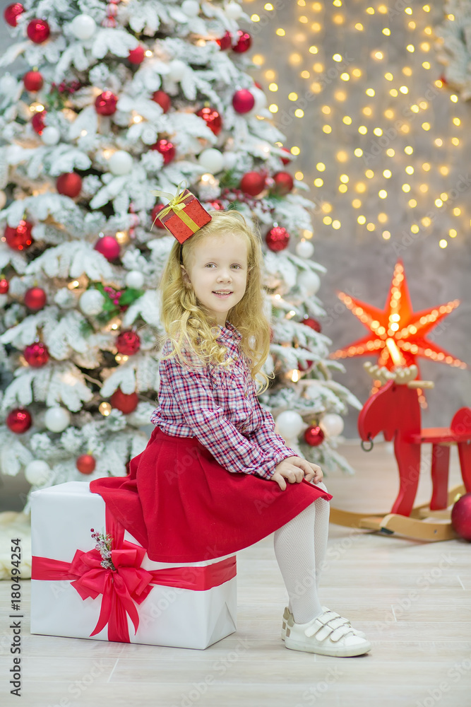Christmas xmas casual gold studio decorations with cute girl and huge mirror with golden frame plenty presents and big green pine tree Christmas xmas casual gold studio decorations with cute girl and huge mirror with golden frame plenty presents and big green pine tree