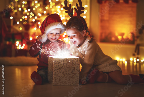 Merry Christmas! happy children with magic  gift  at home