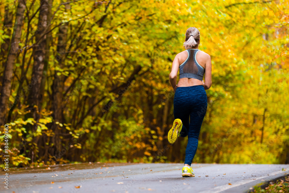 Obraz premium Woman running in the autumn park