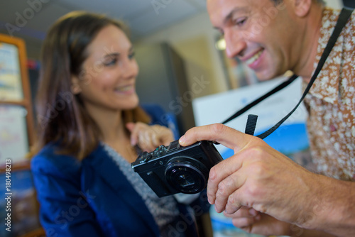 Man showing photos on screen of digital camera