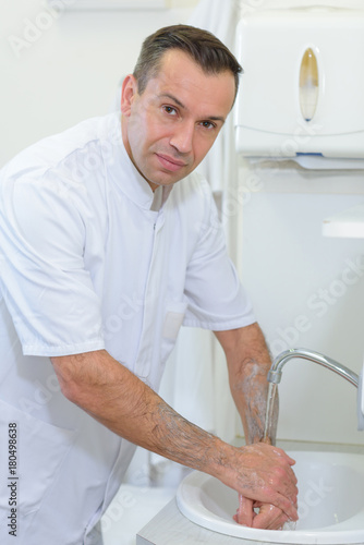 Portrait of doctor washing hands