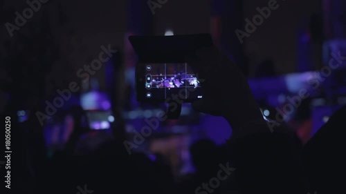 People shoots 3D mapping light show on a mobile phone. photo