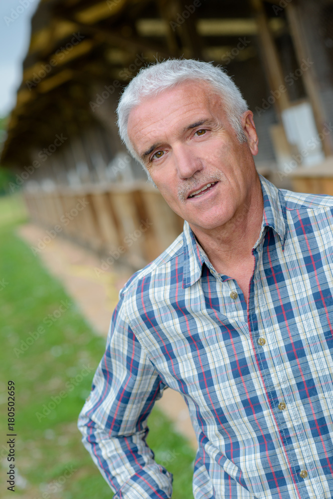 Portrait of man by farm building Portrait of man by farm building