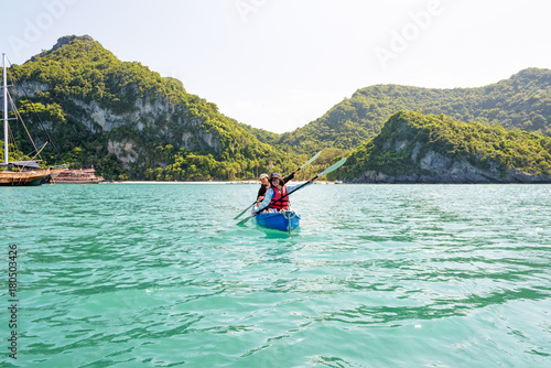 Two women are mother and daughter. Travel by boat with a kayak happy on the sea under the bright summer sky front of Ko Wua Ta lap islands at Mu Ko Ang Thong National Park, Surat Thani, Thailand © yongkiet