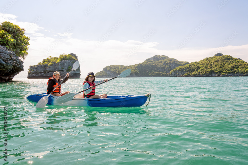 Two women are mother and daughter. Travel by boat with a kayak under sky summer around Ko Phi view the beautiful nature of the sea and island, Mu Ko Ang Thong National Park, Surat Thani, Thailand