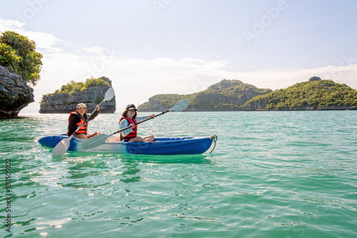 Two women are mother and daughter. Travel by boat with a kayak under sky summer around Ko Phi view the beautiful nature of the sea and island, Mu Ko Ang Thong National Park, Surat Thani, Thailand