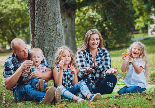 Young family with cheerful children in the park