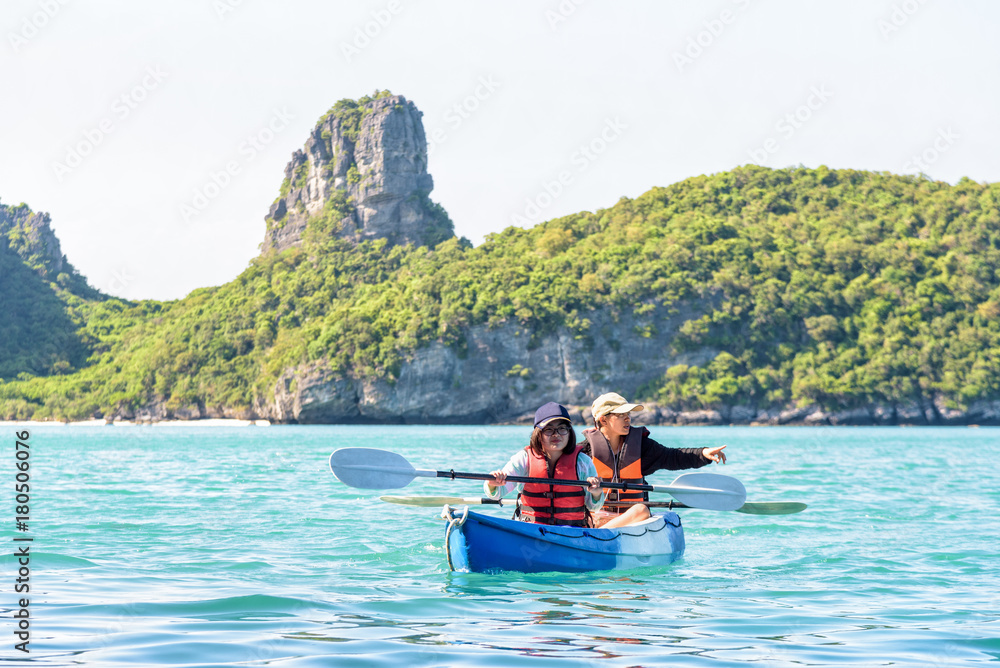 Two women are mother and daughter. Happy family travel by kayak around Ko Mae Ko view the beautiful nature of the sea and island during summer at Mu Ko Ang Thong National Park, Surat Thani, Thailand