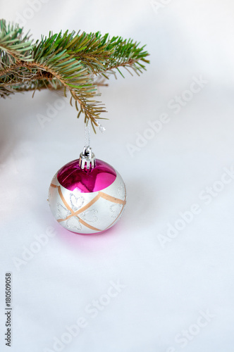 New Year's silver ball hanging on a spruce branch