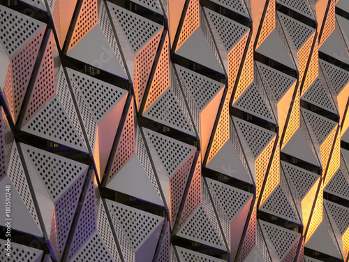 modern steel angular geometric cladding with colour tones and perforated patterned design