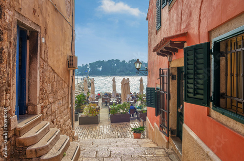 Romantic Rovinj street with a sea view.Idyllic street with old houses in town of Rovinj, Istria, Croatia photo