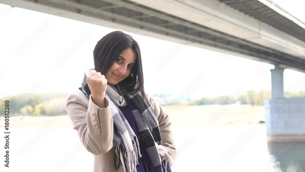 The aggressive girl is annoyed and showing a fist. Lose control The aggressive girl is annoyed and showing a fist. Lose control