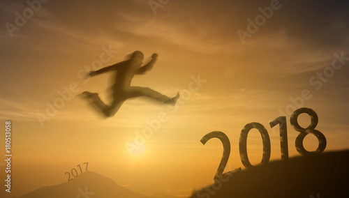 2018 brave man successful concept silhouette man jumping over the sun between gap of the mountain from 2017 to 2018 new year   it feel like a winner  success  finish reach a goal of live  jobs work