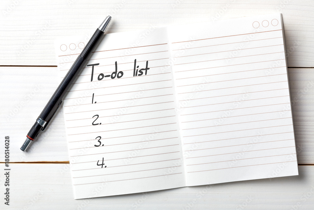 Opened personal organizer with a to do list. on white wooden background Opened personal organizer with a to do list. on white wooden background