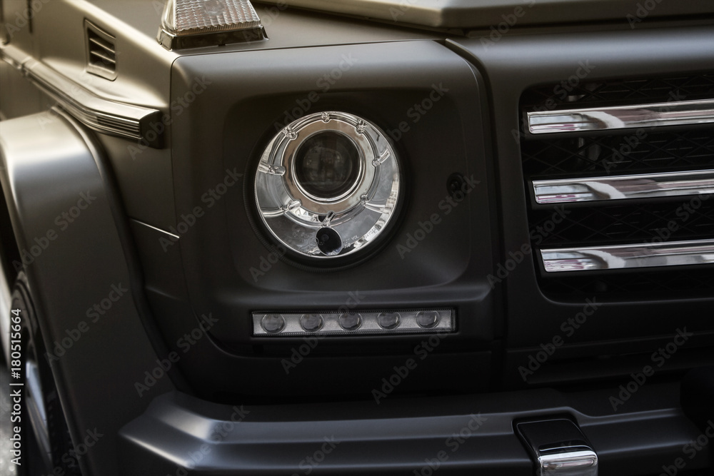 Suv car headlight photo with grille.