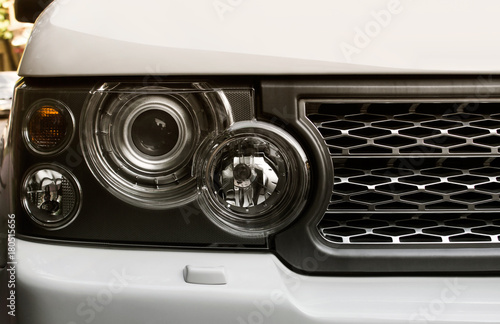 Картината върху платно Suv car headlight photo with mesh grille.