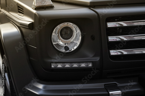 Suv car headlight photo with grille. © breakermaximus