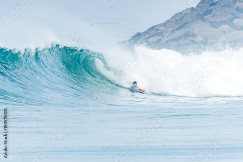 Bodyboarder surfing ocean wave