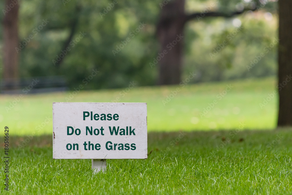please do not walk on grass sign outside on green grass 