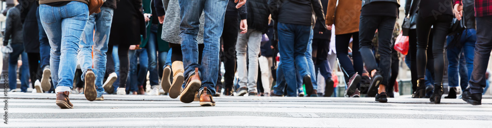 crowds of people in motion blur crossing a city street crowds of people in motion blur crossing a city street