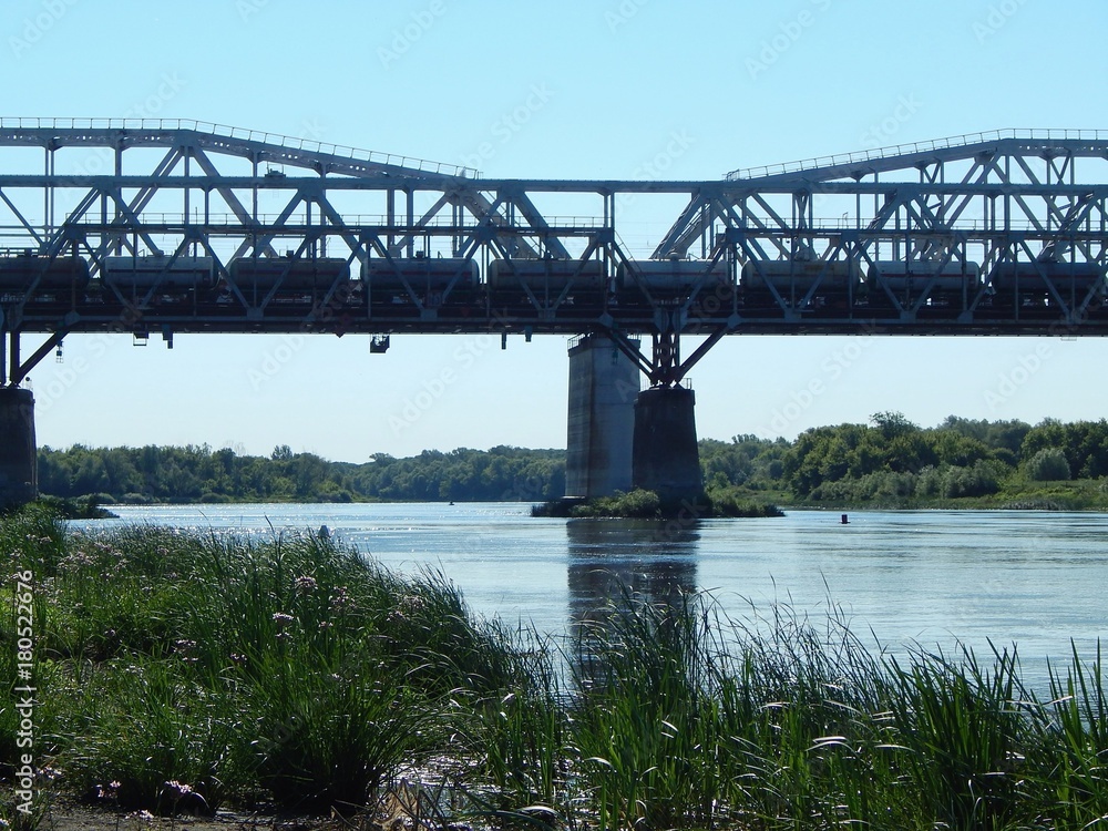 Railway bridge across the river. Pillars and arches of the railway bridge. Photo